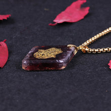 Load image into Gallery viewer, Orgonite Hamsa Natural Garnet Pendant
