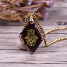 Load image into Gallery viewer, Orgonite Hamsa Natural Garnet Pendant
